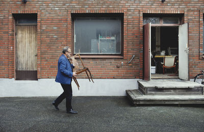 Full length of man standing outside building