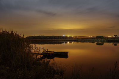 Scenic view of calm lake at sunset