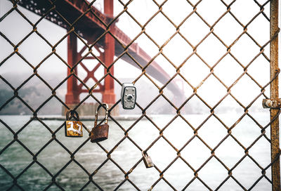 Close-up of padlock on chainlink fence