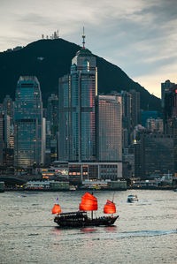 Boat in river with buildings in background