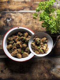 Directly above shot of stew in bowl by potted plant on table