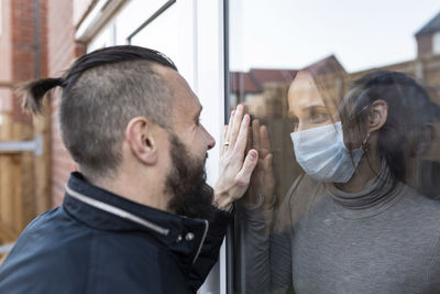 Portrait of man with reflection on mirror