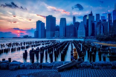 View of buildings against cloudy sky during sunset