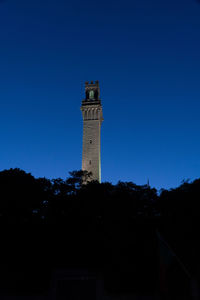 Low angle view of lighthouse against building