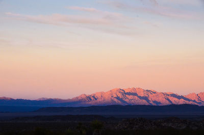 Scenic view of mountains against sky at sunset