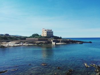 Scenic view of sea against blue sky