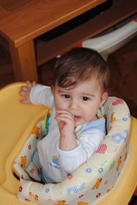 Portrait of cute girl sitting at home