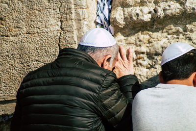 Rear view of people on rock