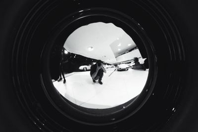 Reflection of people photographing in mirror