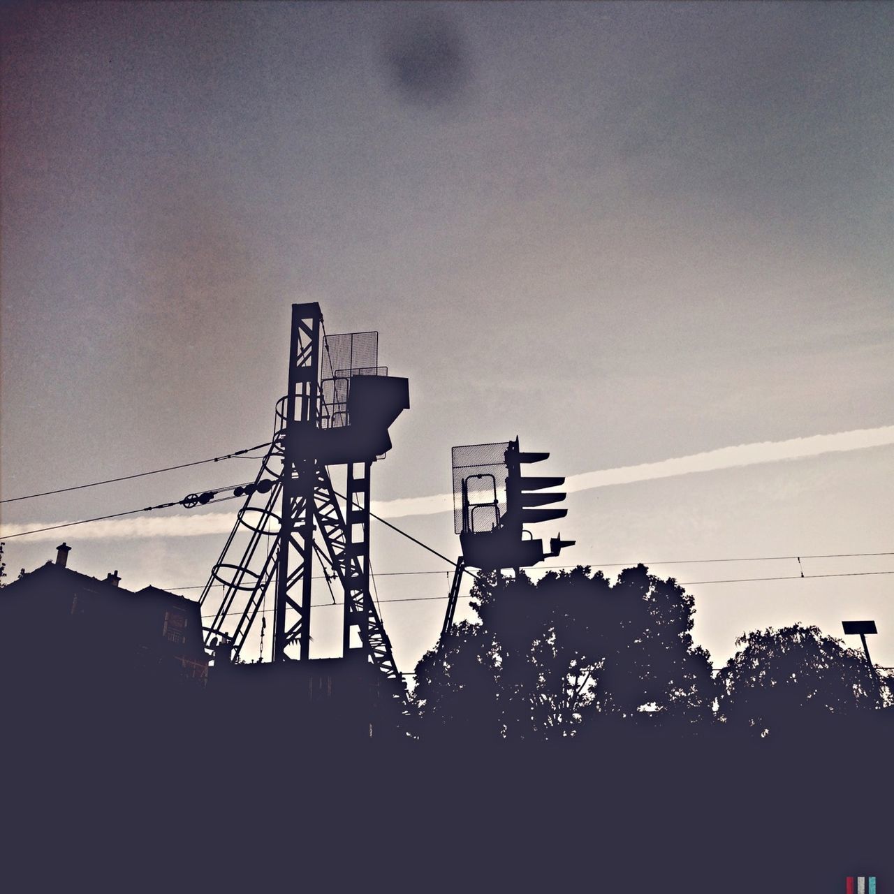 low angle view, silhouette, built structure, sky, electricity, electricity pylon, architecture, power line, clear sky, technology, connection, dusk, copy space, building exterior, tall - high, outdoors, power supply, fuel and power generation, no people, tree