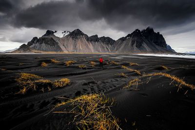 Scenic view of snowcapped mountains against cloudy sky