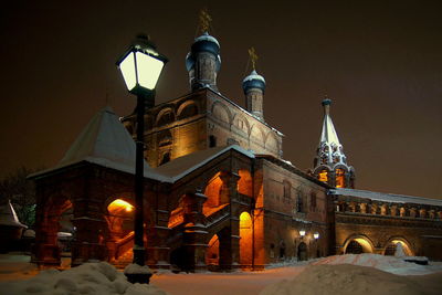 Illuminated cathedral against sky during winter at night