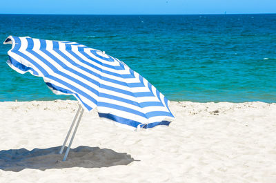 Scenic view of beach against blue sky