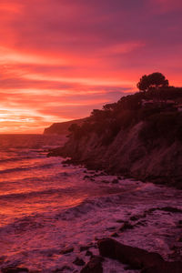 Scenic view of sea against orange sky