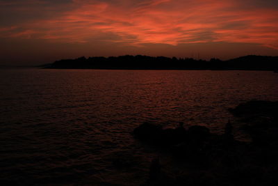 Scenic view of sea against orange sky