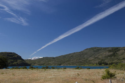 Scenic view of landscape against blue sky