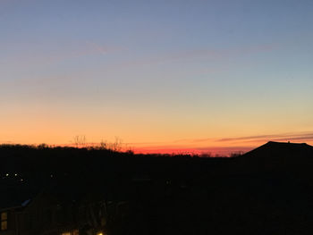 Silhouette landscape against sky during sunset