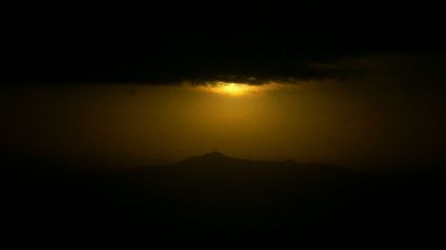 Scenic view of mountains against sky at sunset