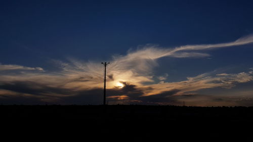 Silhouette landscape against sky during sunset