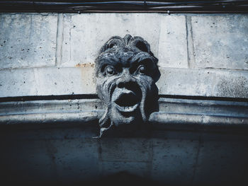 Low angle view of statue against wall