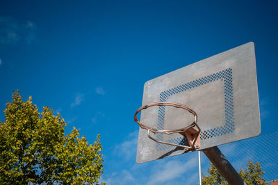 Low angle view of street light against blue sky