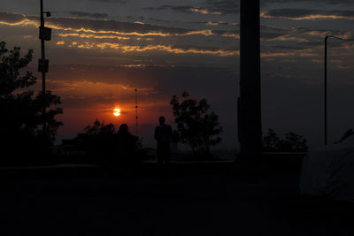 Silhouette trees against sky during sunset