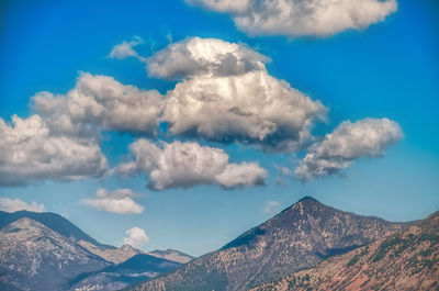 Low angle view of clouds over mountain