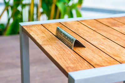 Close-up of no smoking sign on table