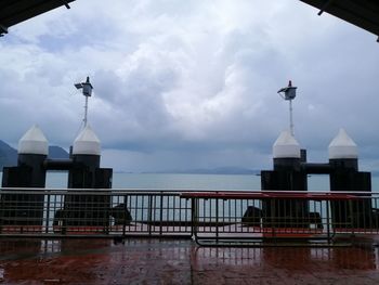 Buildings by sea against sky