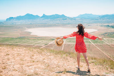 Full length of woman standing on mountain