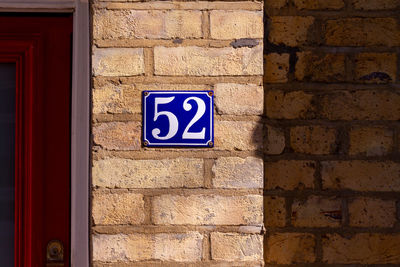 House number 52 on a brick wall in london