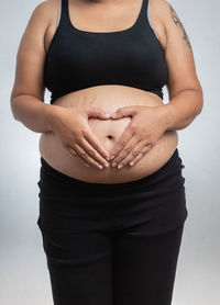 Midsection of a woman touching hair