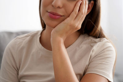 Young woman with her face resting on her hand. toothache. depression. mental health. 