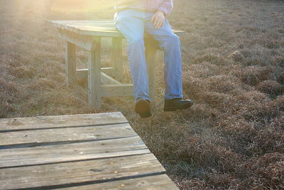 Low section of man sitting on wooden floor