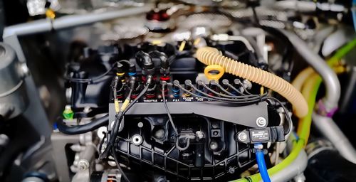 Close-up of machine engine part and cable