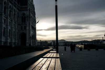 Silhouette of building against cloudy sky