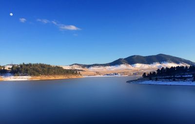 Scenic view of mountains against blue sky