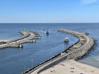 High angle view of boats in sea against clear blue sky