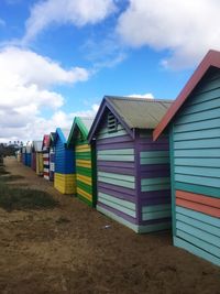 Multi colored umbrellas on beach against sky