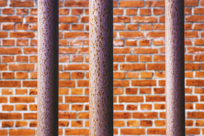 Full frame shot of brick wall with railings in foreground