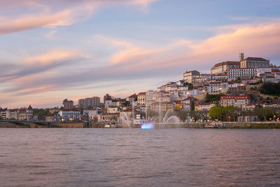 Coimbra city view at sunset with mondego river and beautiful historic buildings, in portugal