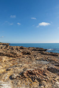 Scenic view of beach against blue sky