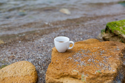 Coffee cup on rock