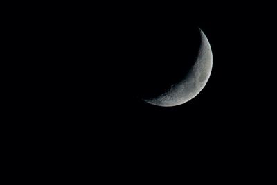 Low angle view of moon against sky at night