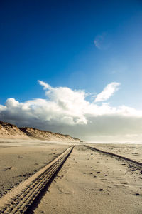 Railroad track against blue sky