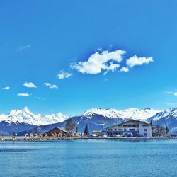 Scenic view of snowcapped mountains against blue sky