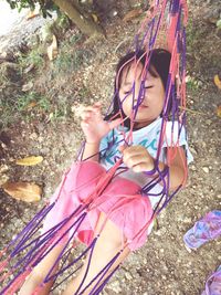 High angle view of girl sitting on land