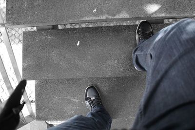 Low section of woman standing on tiled floor