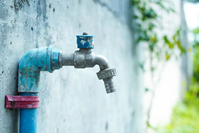 Close-up of faucet against wall