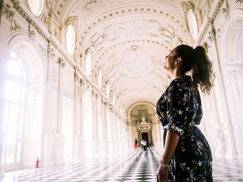 Woman standing against building